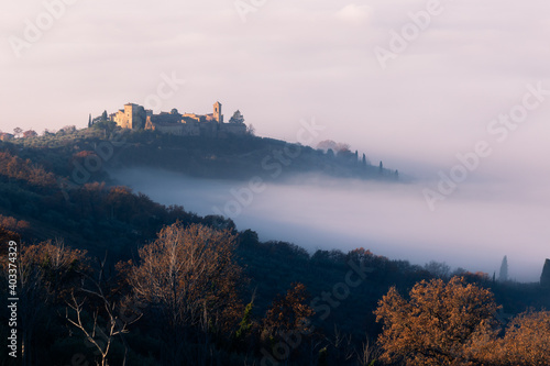 Little town in Umbria (Italy) over a sea of fog at dawn