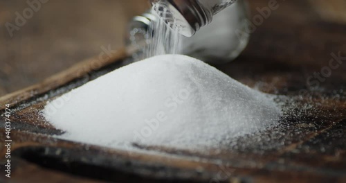 Salt is poured on the cutting board. 