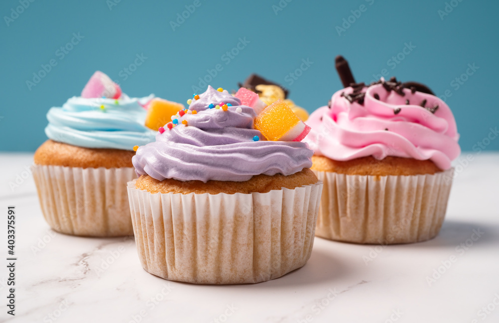 Delicious homemade cupcakes with Colorful cream and topping with candy and Chocolate Cookies. Homemade autumn holiday dessert Delicious homemade cupcakes with Colorful cream and topping with candy and Chocolate Cookies. Homemade autumn holiday dessert