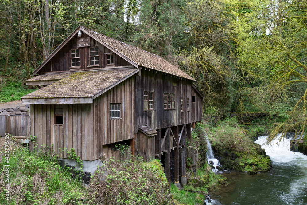 An eye level view of Cedar Creek grist mill from the bridge looking towards the mill and river An eye level view of Cedar Creek grist mill from the bridge looking towards the mill and river