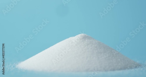 A pile of salt on the table is slowly rotating.