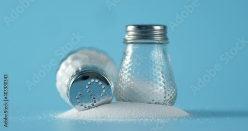 Cans of salt slowly rotate on the table.