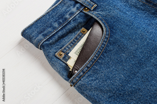 A few hundred dollars banknotes in a jeans pocket in your wallet. The concept of wealth and salary for work.