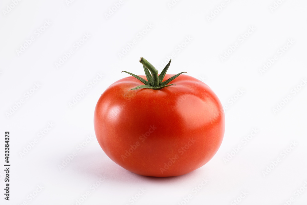 Red round tomato on white background