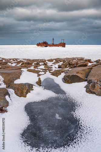 The shipwreck, MV Ithaca, Ithaka in Churchill, northern Manitoba, Canada in fall, autumn time of year, season on the icy tundra of Hudson Bay, sea ice ocean.  photo