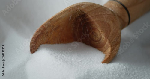 The scoop with salt slowly rotates. 