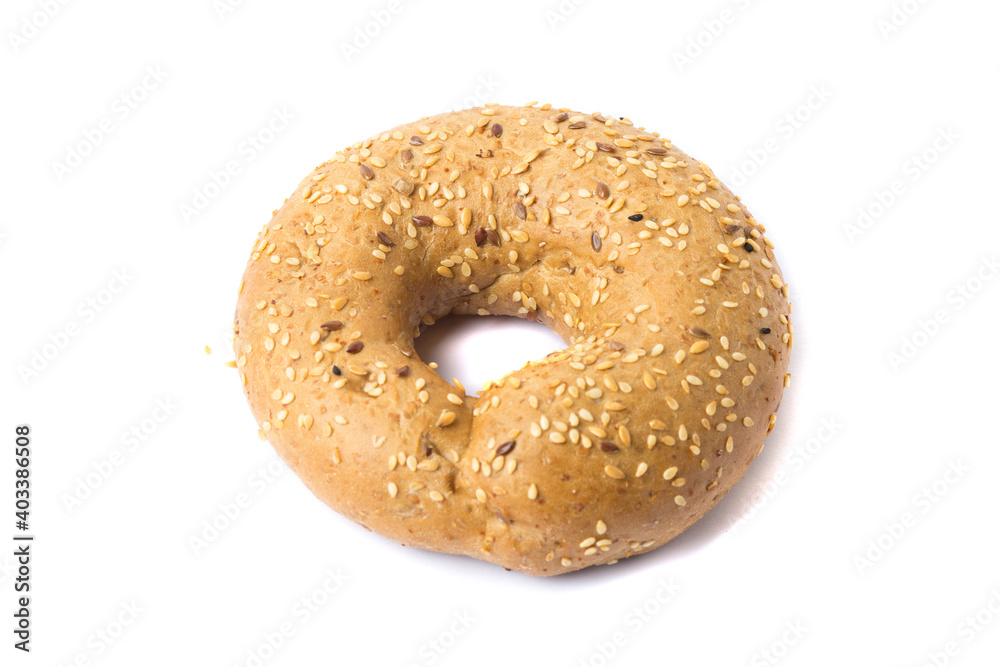 Traditional whole wheat bagel with linseeds and sesame seeds isolated on white Traditional whole wheat bagel with linseeds and sesame seeds isolated on white