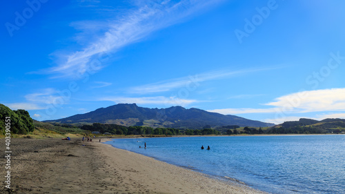 The black sand beach at Raglan, New Zealand, with Mount Karioi on the horizon