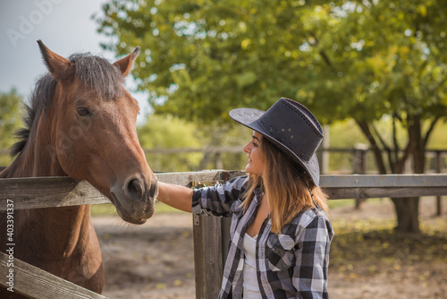 Horse farm concept, hobby - rider. Woman talk with a horse, eco tourism 