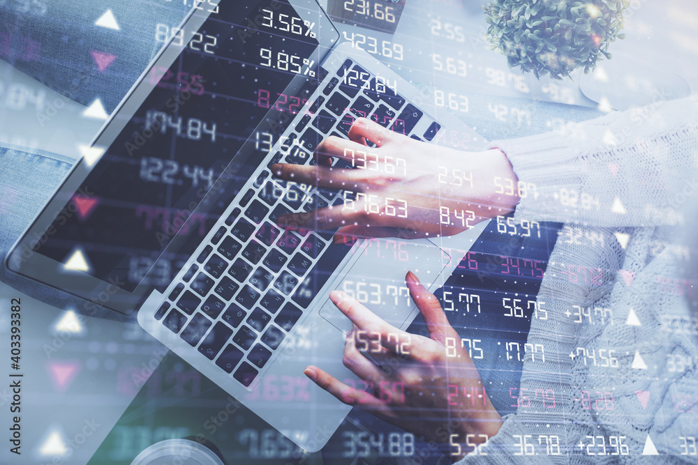 Double exposure of woman hands working on computer and forex chart hologram drawing. Top View. Financial analysis concept. Double exposure of woman hands working on computer and forex chart hologram drawing. Top View. Financial analysis concept.