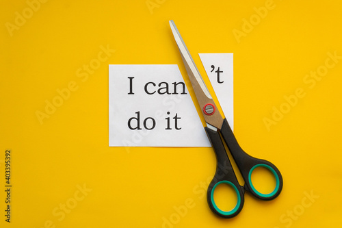 Paper with text I can't do it and scissors on yellow background
