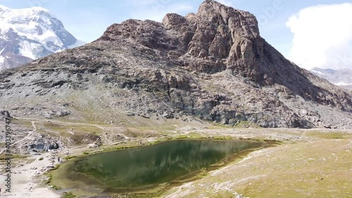 Aerial view of alpine meadows around Riffelsee Lake with Mount Matterhorn or Mont Cervin and Swiss Alps along riffelseeweg trail on Gornergrat Bahn cog railway. Zermatt, Canton of Valais, Switzerland. photo