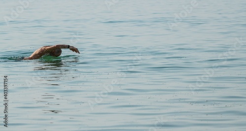 side view of a man swimming in the sea