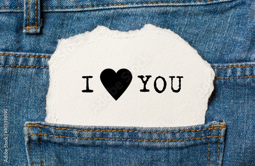 I love you on torn paper background on jeans love and valentine concept