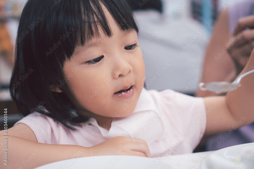 Asain cute girl eat dessert pancake with spoon. Concept for kid and family lifestyle. Asain cute girl eat dessert pancake with spoon. Concept for kid and family lifestyle.
