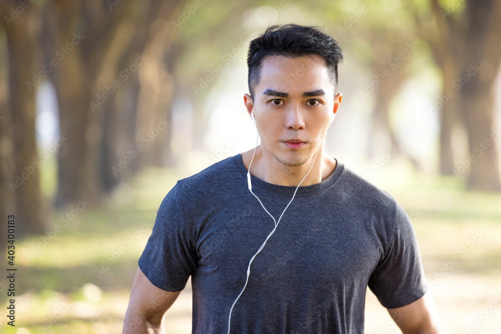 Handsome asian young man exercising in the park at morning Handsome asian young man exercising in the park at morning