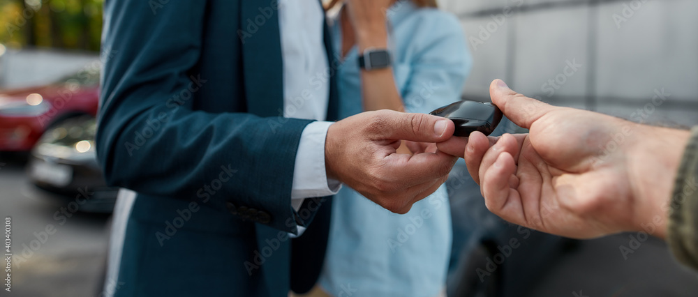 Car keys given to businessman by sales manager Car keys given to businessman by sales manager