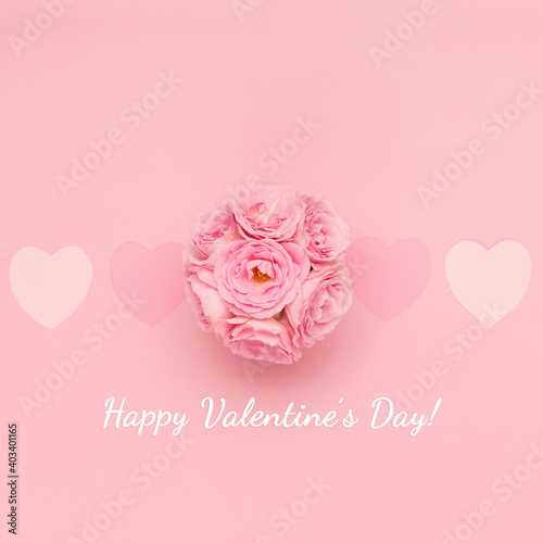 Flowers roses and pink paper hearts on pink background. Valentines day concept. Flat lay, top view, copy space.