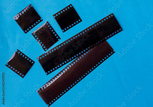 old film negatives on a plain blue colour background