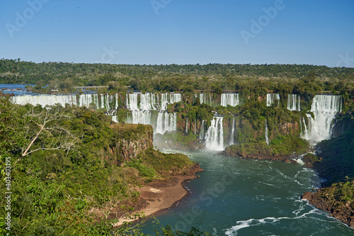 Iguazu Falls or Iguacu Falls  on the border of Argentina and Brazil  are the largest waterfall in the world. Very high waterfall with white water in beautiful rain forest landscape in the jungle