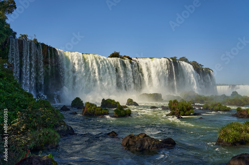 Iguazu Falls or Iguacu Falls, on the border of Argentina and Brazil, are the largest waterfall in the world. Very high waterfall with white water in beautiful rain forest landscape in the jungle