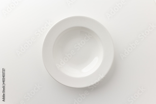 Top view White empty plates on a white table. Household equipment