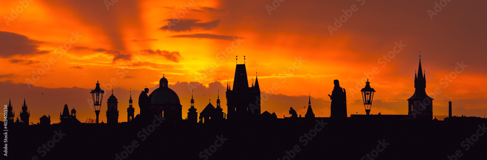 Silhouette of the towers of the old town of Prague at sunrise