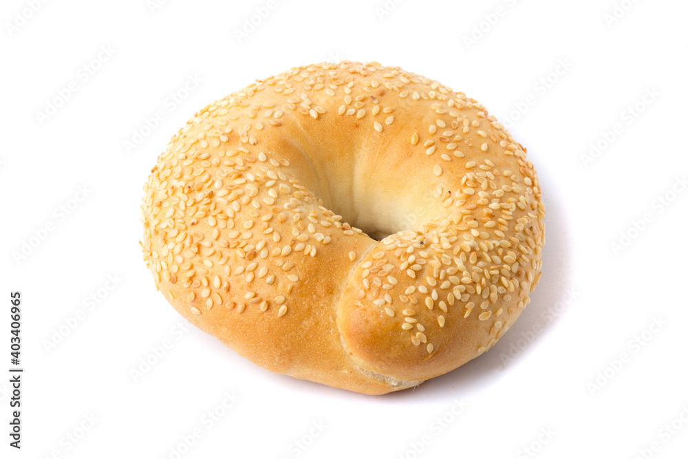 Traditional whole wheat bagel with sesame seeds isolated on white Traditional whole wheat bagel with sesame seeds isolated on white