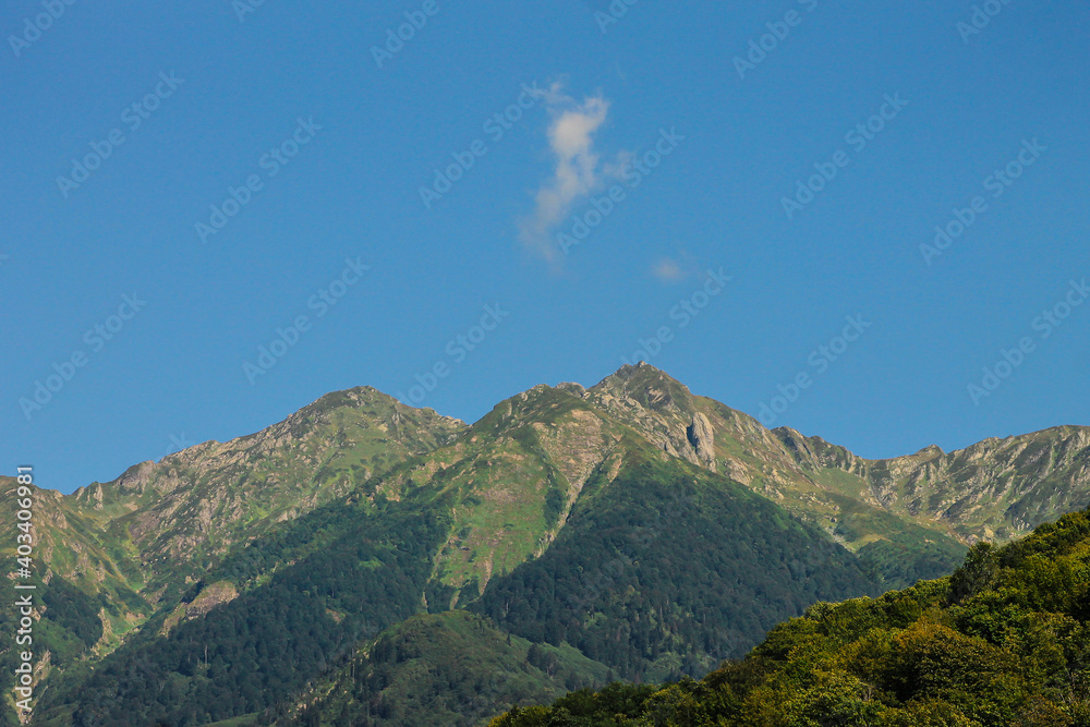 Green mountain landscape, clear blue sky