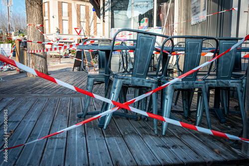 Emptyfrench terrace cafe closed and taped off to stop people sitting on the terrace because of coronavirus shutdown ,covid 19 .