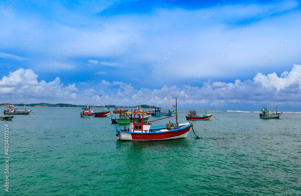 Background Colorful fishing boats and trawlers at a sea in Sri Lanka.