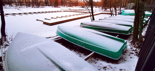  A winter view of the lake with upside boats on the shore