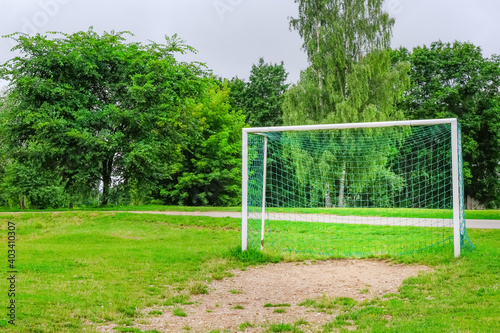 empty soccer field with soccer goal in countryside in meadow