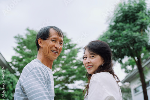 Portrait of senior couple standing together at park.