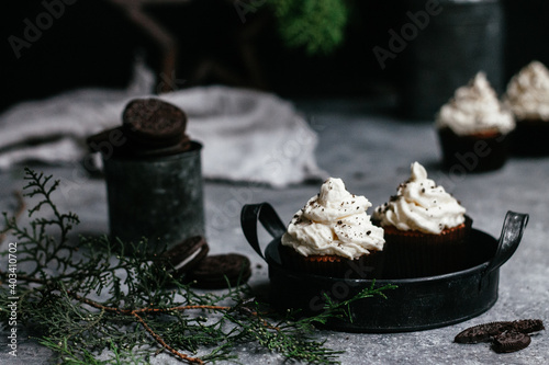 chocolate muffins with cream on gray background