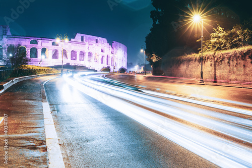 Rome  Italy. Colosseum View From Another Side In Night Time. Night Traffic Light Trails Near Famous World Landmark