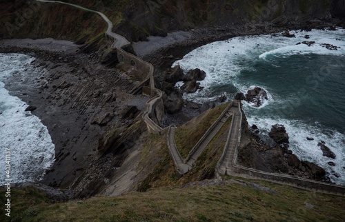 Panoramic view of stone staircase footbridge to Gaztelugatxe islet rock castle hermitage chapel Bermeo Basque Spain photo