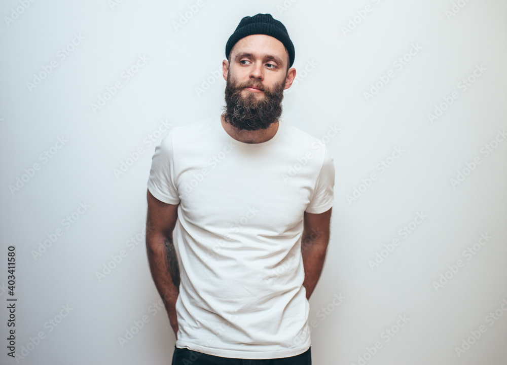 Young bearded hipster guy wearing white blank t-shirt. Mock-up for print. T-shirt template. Young bearded hipster guy wearing white blank t-shirt. Mock-up for print. T-shirt template.
