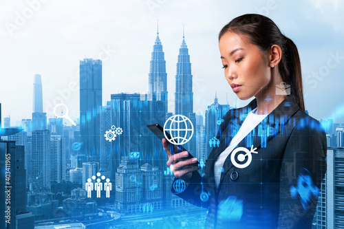 Photography Attractive Asian businesswoman trying to find new ideas using smartphone as a modern tool to solve problems at research and development department