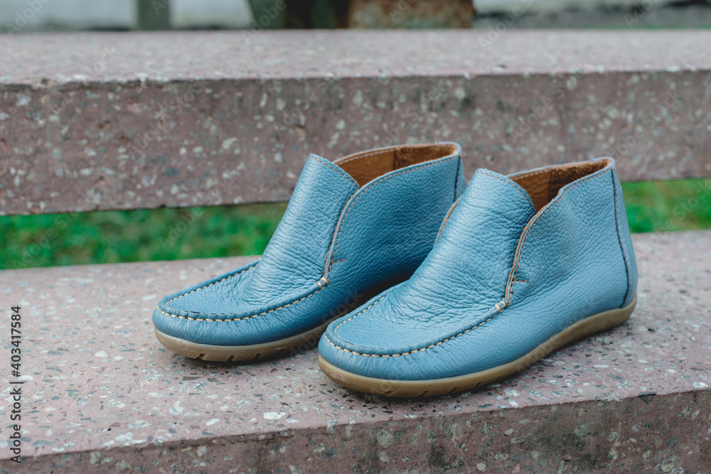 men's shoes moccasins blue color. photo on the street