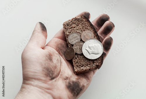coins money in dirty hand on white background, poverty concept 