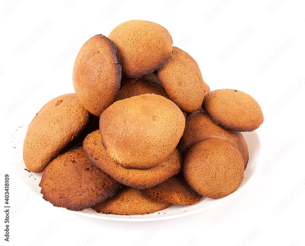 Brown homemade round shape cookies lined with a slide on a plate on a white isolated background in a photo studio. Sugar-free dietary oatmeal cookies with fructose. Brown homemade round shape cookies lined with a slide on a plate on a white isolated background in a photo studio. Sugar-free dietary oatmeal cookies with fructose.
