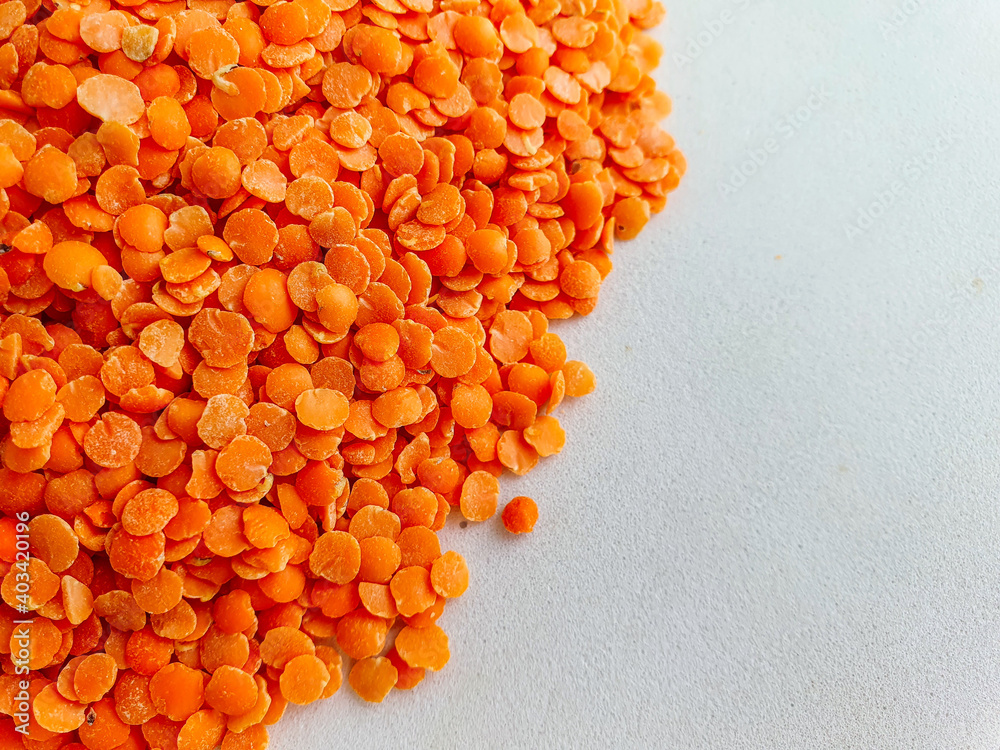 dried orange lentils. Red lentils on white background. Top view. Food background dried orange lentils. Red lentils on white background. Top view. Food background