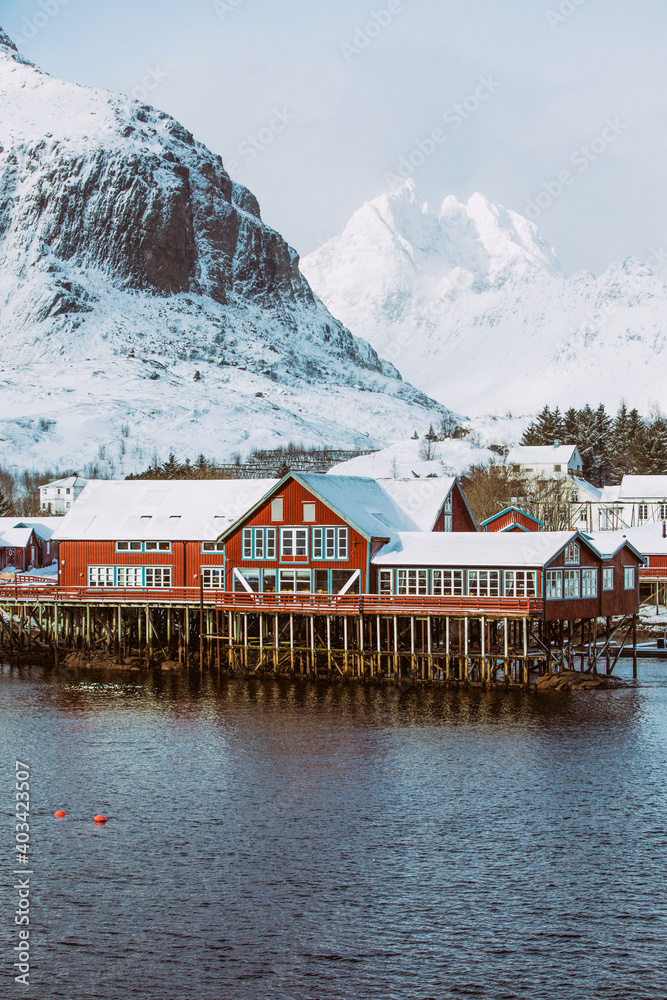 Norway. Lofoten. Red house on the water in the background of the mountains.