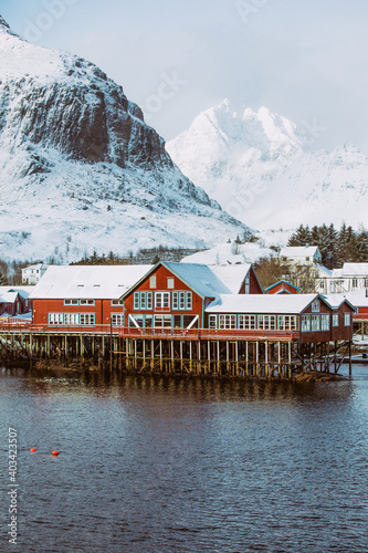 Norway. Lofoten. Red house on the water in the background of the mountains.