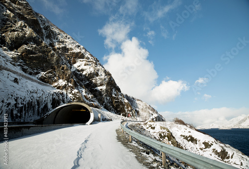 Norway. Lofoten. Beautiful landscape. Road, tunnel, mountains and blue sky.