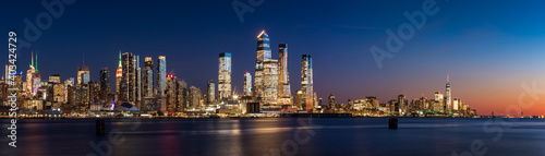 View across Hudson River of skyscrapers of New York City. Manhattan skyline at sunset from Midtown West to Lower Manhattan (Hudson Yards and World Trade Center). NY, USA