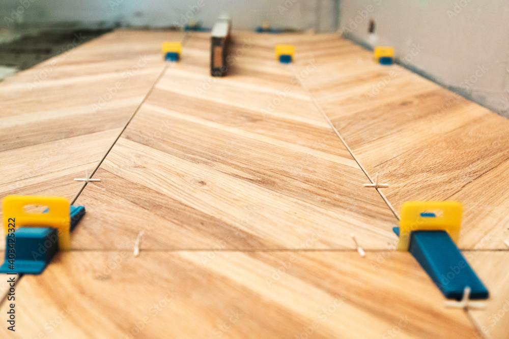 Tiling work. Layed tiles with crosses for tiles and 3d crosses Stock