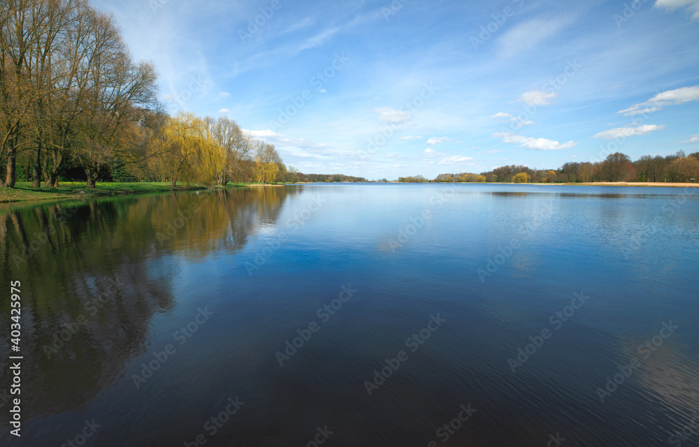 The Nesvizh park. Beautiful and clean lake against the blue sky.