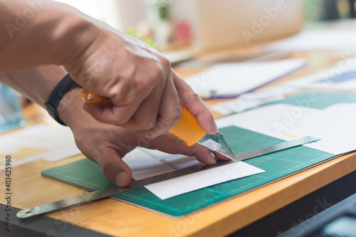 close up of hands cutting paper